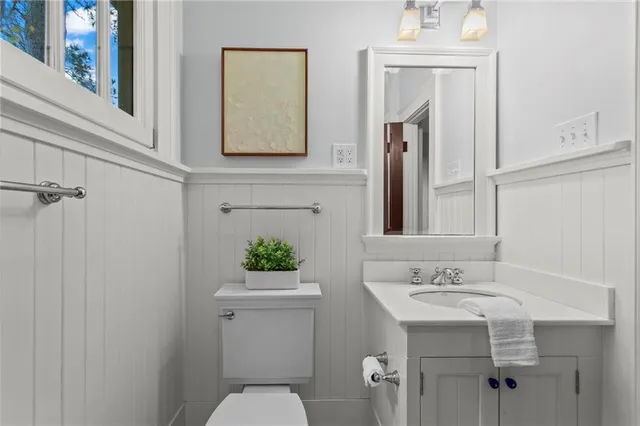 a bathroom with a sink vanity mirror and toilet
