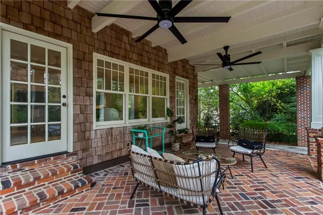 a building outdoor space with patio furniture and garden