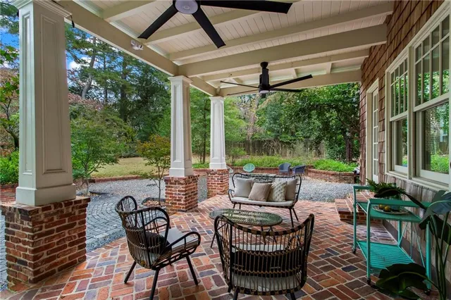 a view of an outdoor sitting area with furniture and garden view