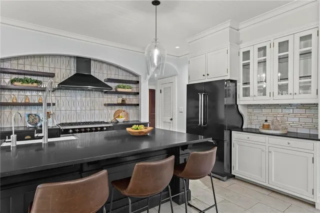 a kitchen with stainless steel appliances a sink stove and refrigerator