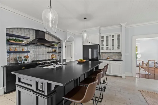 a kitchen that has a table chairs stainless steel appliances and cabinets