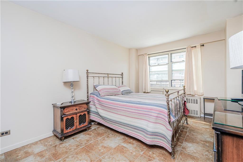 2930 West 5th Street, Unit 5F Brooklyn, NY 11224 - Photo 11 of 20 a bed room with a bed and a night stand