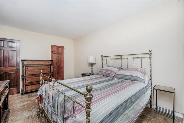 a bedroom with a bed and dresser