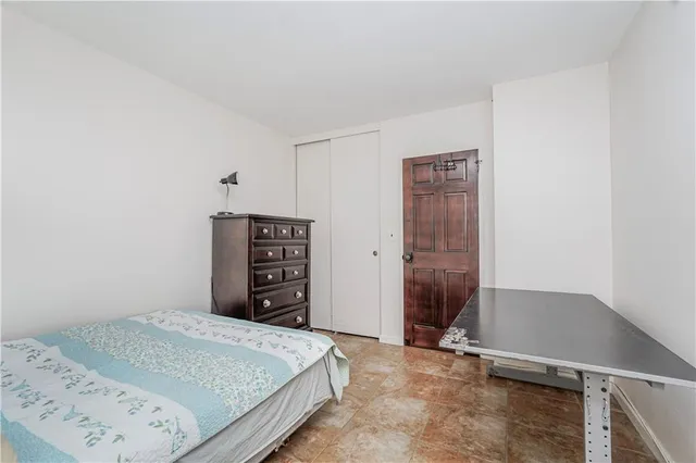 a bedroom with a bed and cabinets