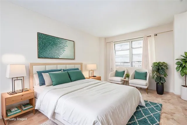 a bedroom with a large bed and a window