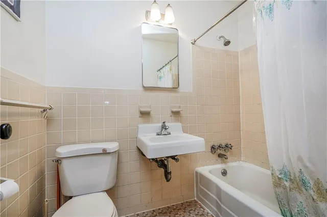 a bathroom with a sink a toilet and bathtub
