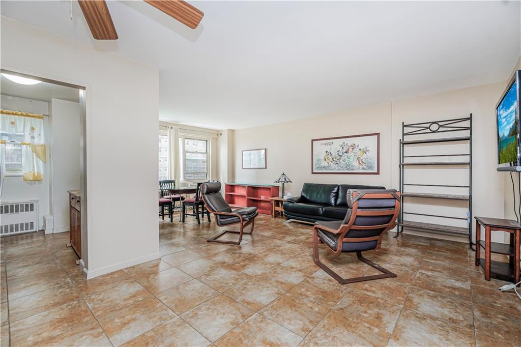 2930 West 5th Street, Unit 5F Brooklyn, NY 11224 - Photo 5 of 20 a living room with furniture a piano and a window