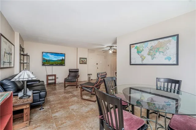 a living room with furniture a wooden floor and a bookshelf