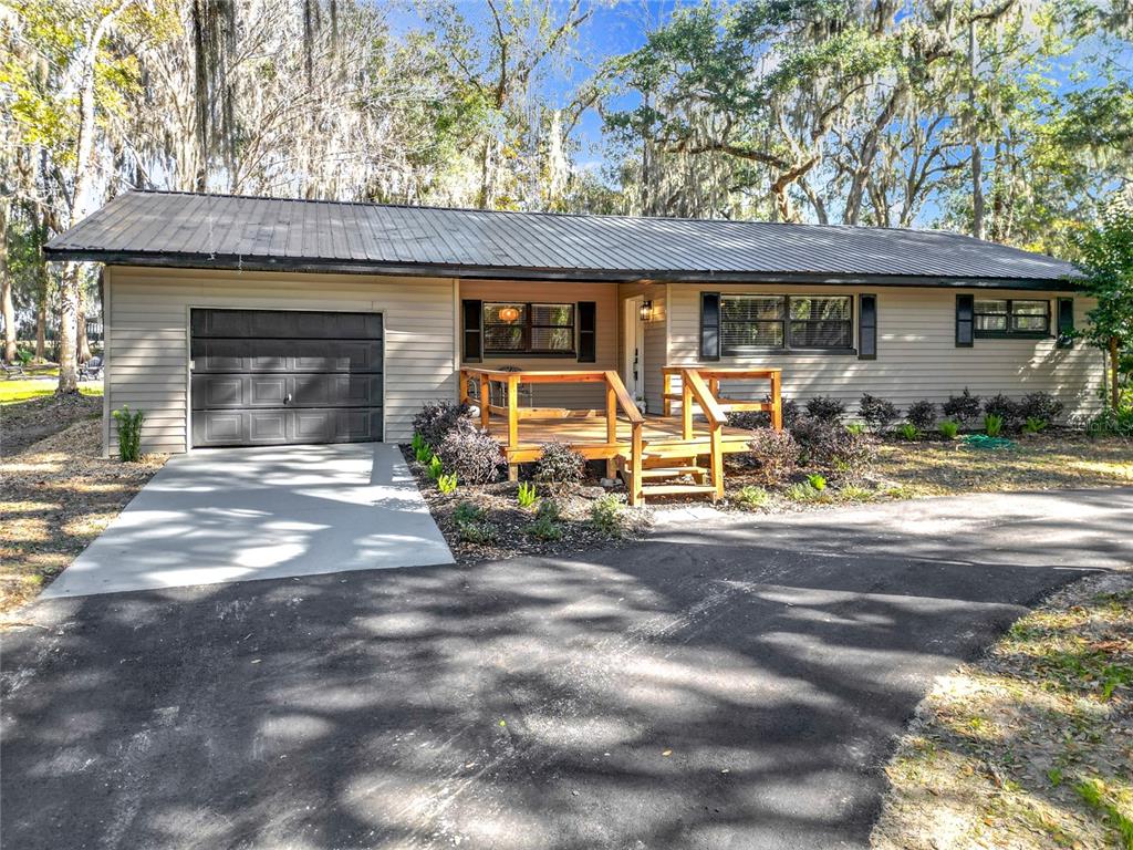 7131 Southwest 19th Avenue Road Ocala, FL 34476 - Photo 1 of 1 a front view of a house with garage