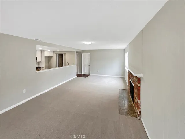 an empty room with windows and entrance