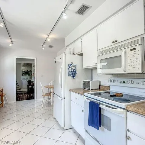 a kitchen with stainless steel appliances a sink stove and cabinets