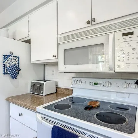 a kitchen with a stove and a microwave