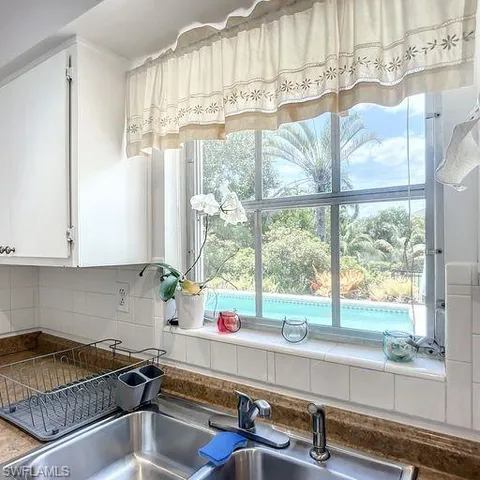 a kitchen with a sink a counter and cabinets