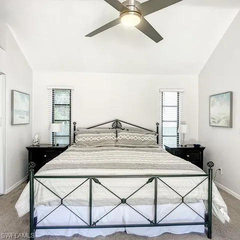 a bedroom with a bed and a dresser with mirror