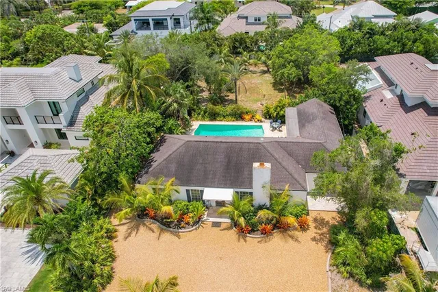 an aerial view of multiple houses with yard