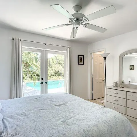 a bedroom with a large bed and a large window