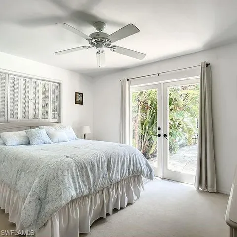 a bedroom with a large bed and a large window