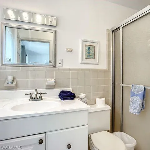 a bathroom with a sink a toilet and mirror