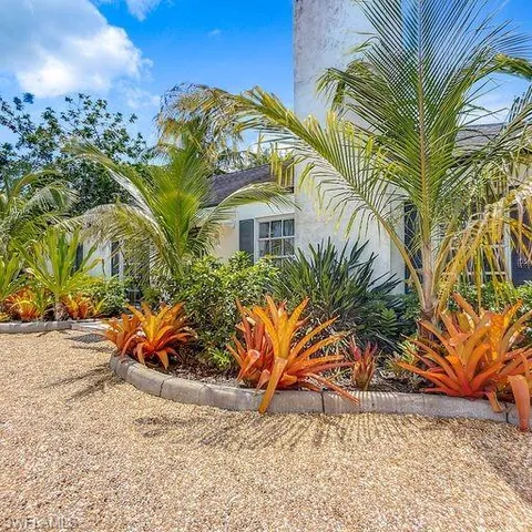 a view of a palm trees in front of a house