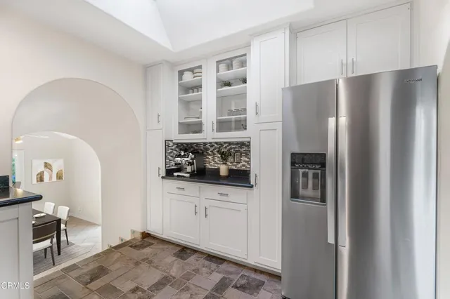 a kitchen with stainless steel appliances a refrigerator and a sink