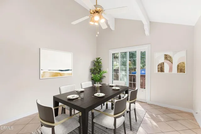 a view of a dining room with furniture and chandelier