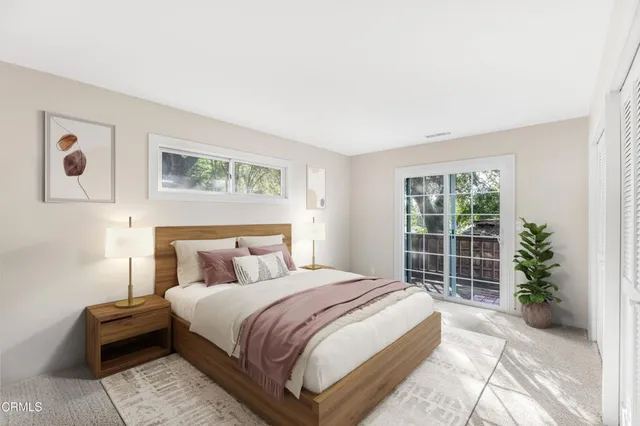a bedroom with a large bed and a potted plant