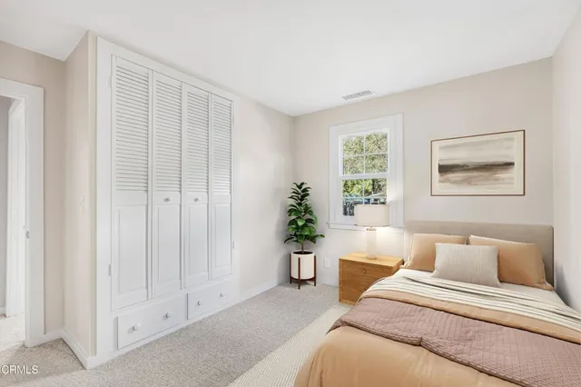 a spacious bedroom with a bed and a window