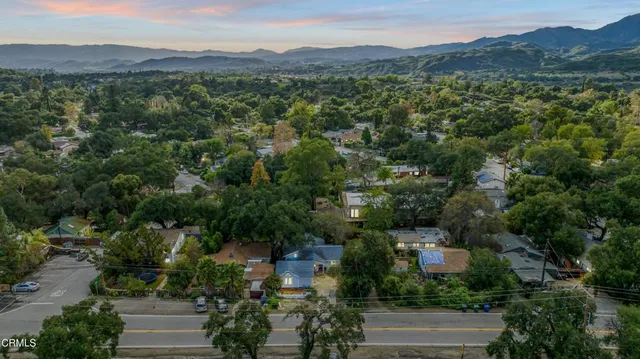 an aerial view of a house with a yard and garden