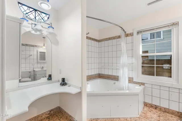 a bathroom with a bathtub and a shower