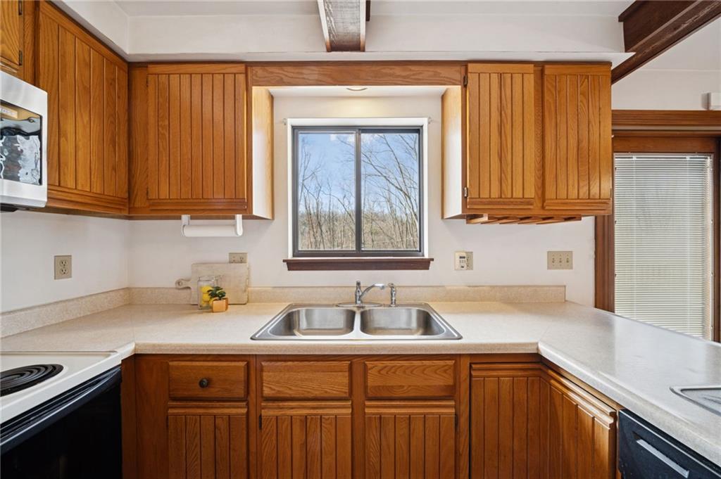 2530 Pleasant Valley Road Murrysville, PA 15668 - Photo 11 of 33 a kitchen with stainless steel appliances wooden cabinets a sink and a window