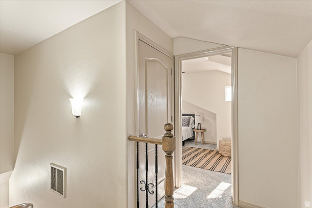 345 North 2450th Street East, Unit 152 St. George, UT 84790 - Photo 22 of 40 Hallway featuring light carpet and vaulted ceiling