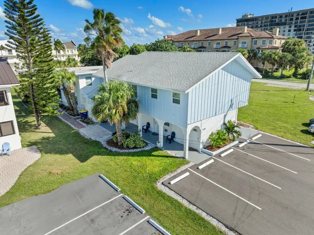 an aerial view of a house with a yard and a garage