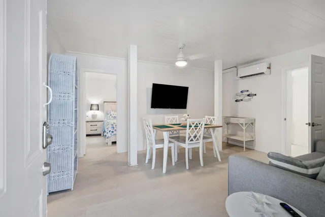 a view of a livingroom with furniture and a flat screen tv