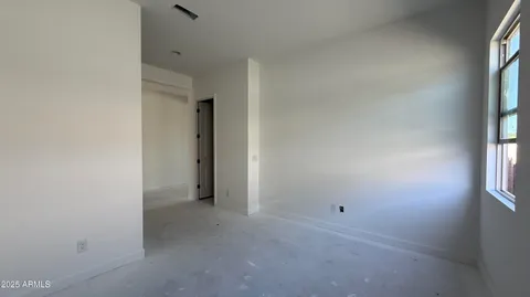 a kitchen with white cabinets and black appliances