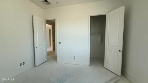 an empty room with windows and closet