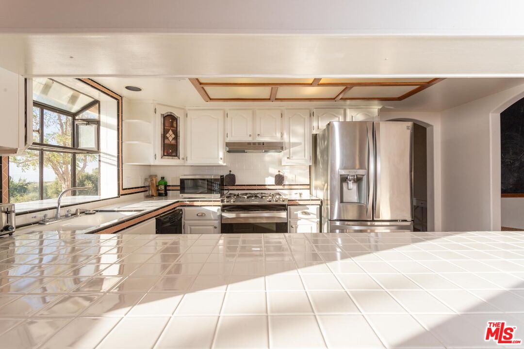 29243 Piani Road Pearblossom, CA 93553 - Photo 12 of 64 a kitchen with granite countertop a sink and a stove top oven
