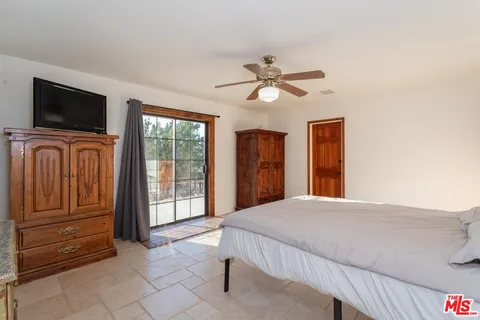 a bedroom with a bed and a television