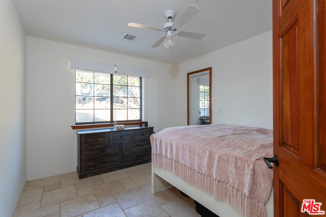 29243 Piani Road Pearblossom, CA 93553 - Photo 20 of 64 a bedroom with a bed and a window