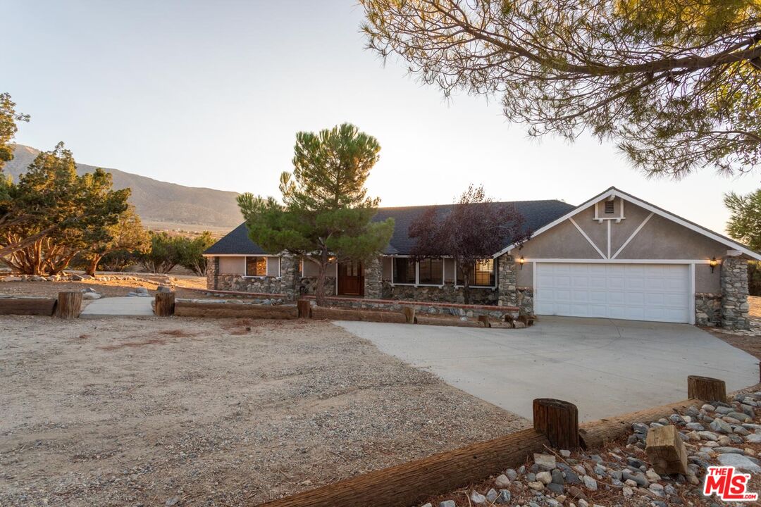 29243 Piani Road Pearblossom, CA 93553 - Photo 2 of 64 a view of a house with a yard covered in snow