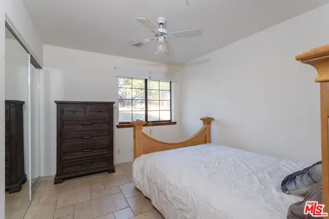 a bedroom with a bed and a closet