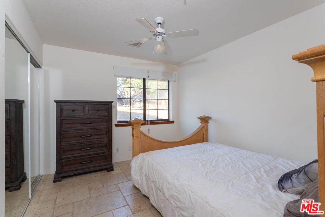 29243 Piani Road Pearblossom, CA 93553 - Photo 21 of 64 a bedroom with a bed and a closet