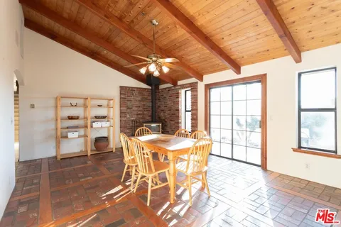 a view of a dining room with furniture and a chandelier