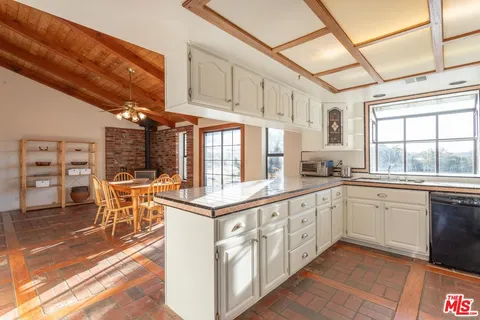 a kitchen with stainless steel appliances granite countertop a stove and cabinets