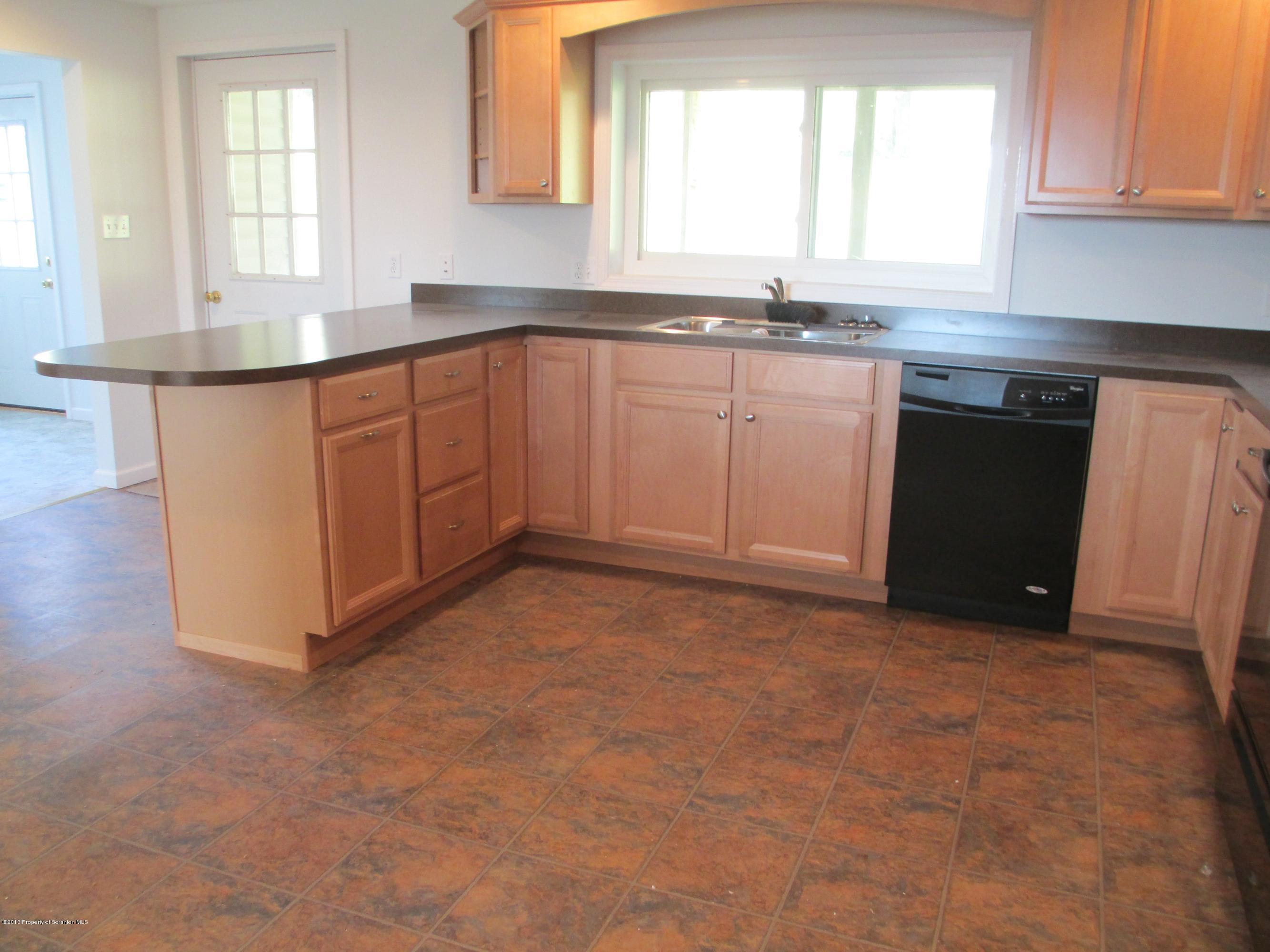 6 Lesher Road Tunkhannock, PA 18657 - Photo 8 of 23 a kitchen with stainless steel appliances granite countertop a sink a stove a cabinets and a window