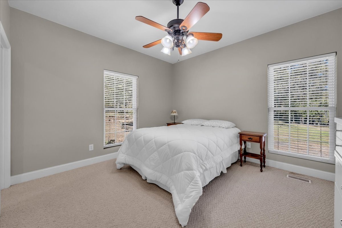 131 Butterfly Lane Bell Buckle, TN 37020 - Photo 17 of 46 a bed sitting in a bedroom next to a window