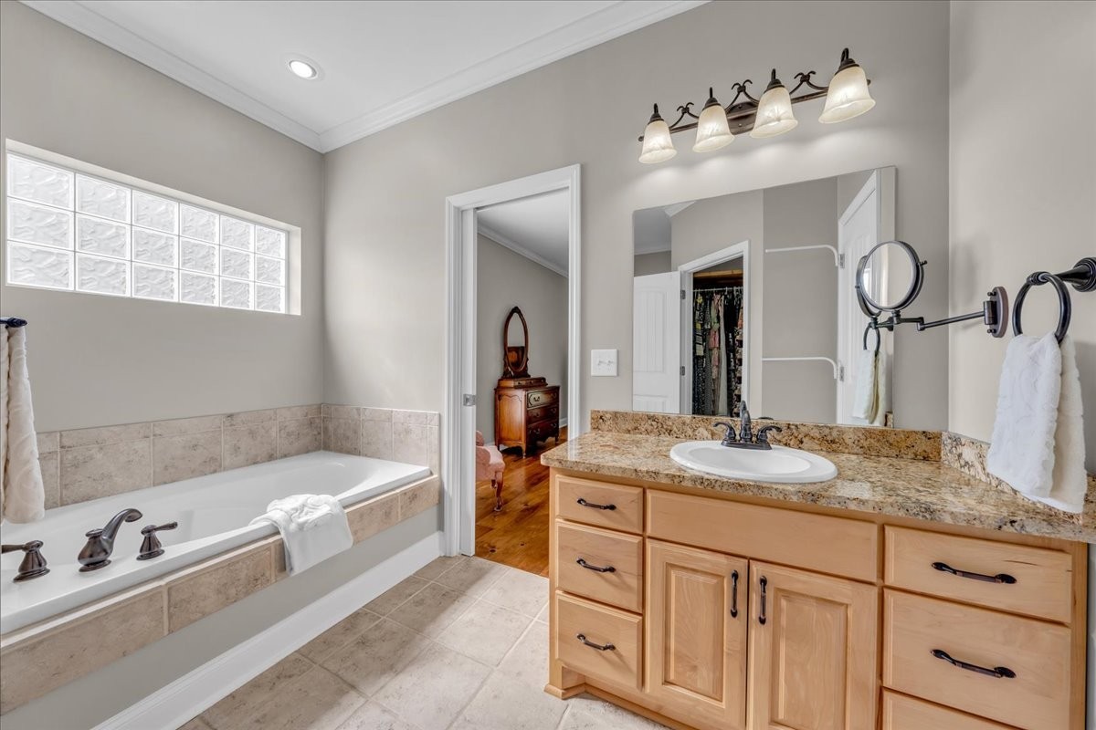 131 Butterfly Lane Bell Buckle, TN 37020 - Photo 23 of 46 a bathroom with a tub double sink window and mirror