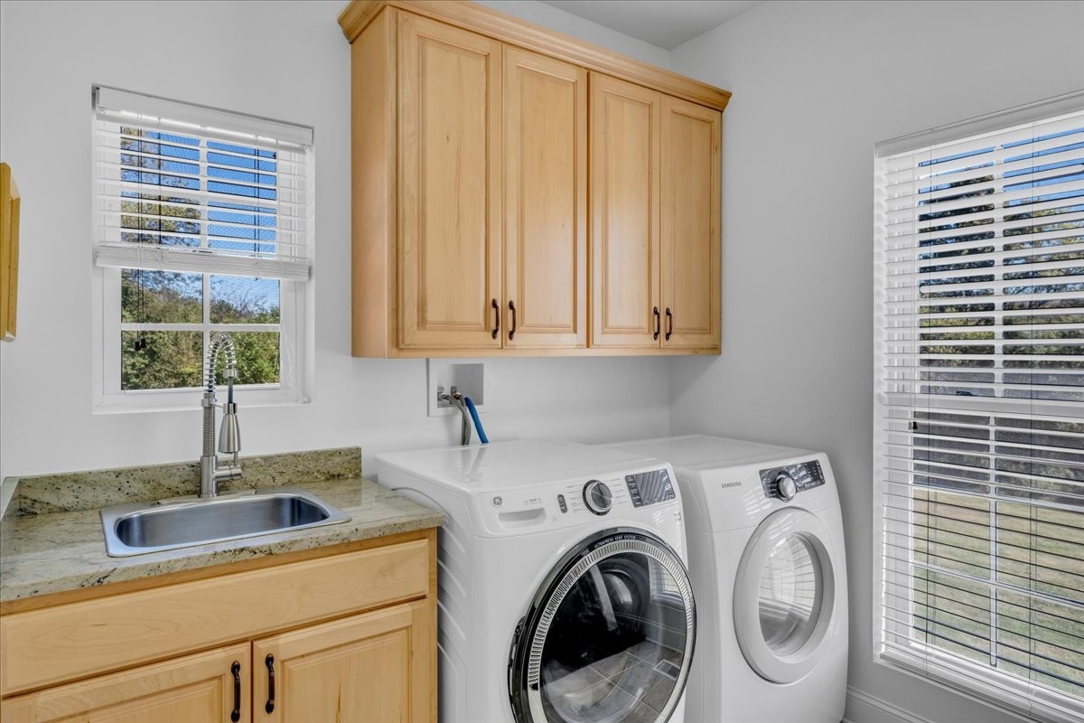 131 Butterfly Lane Bell Buckle, TN 37020 - Photo 25 of 46 a kitchen with a sink a washer and dryer next to a window