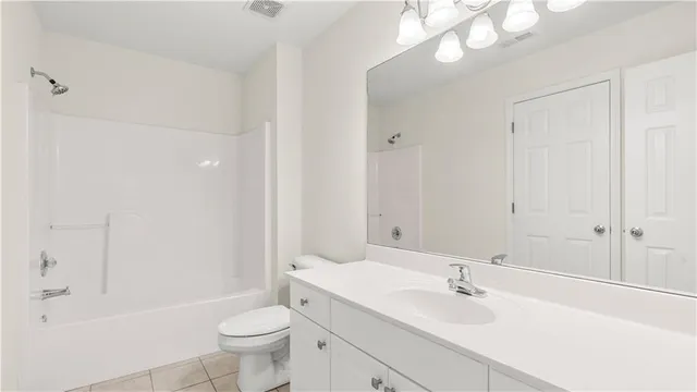 a picture of a bathroom with a white wall