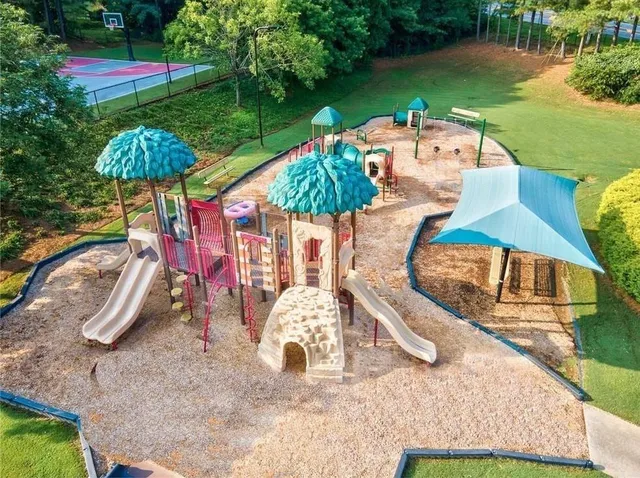 an aerial view of a tennis ground and a houses