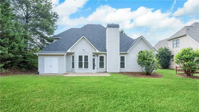a view of a house with a yard and a garden